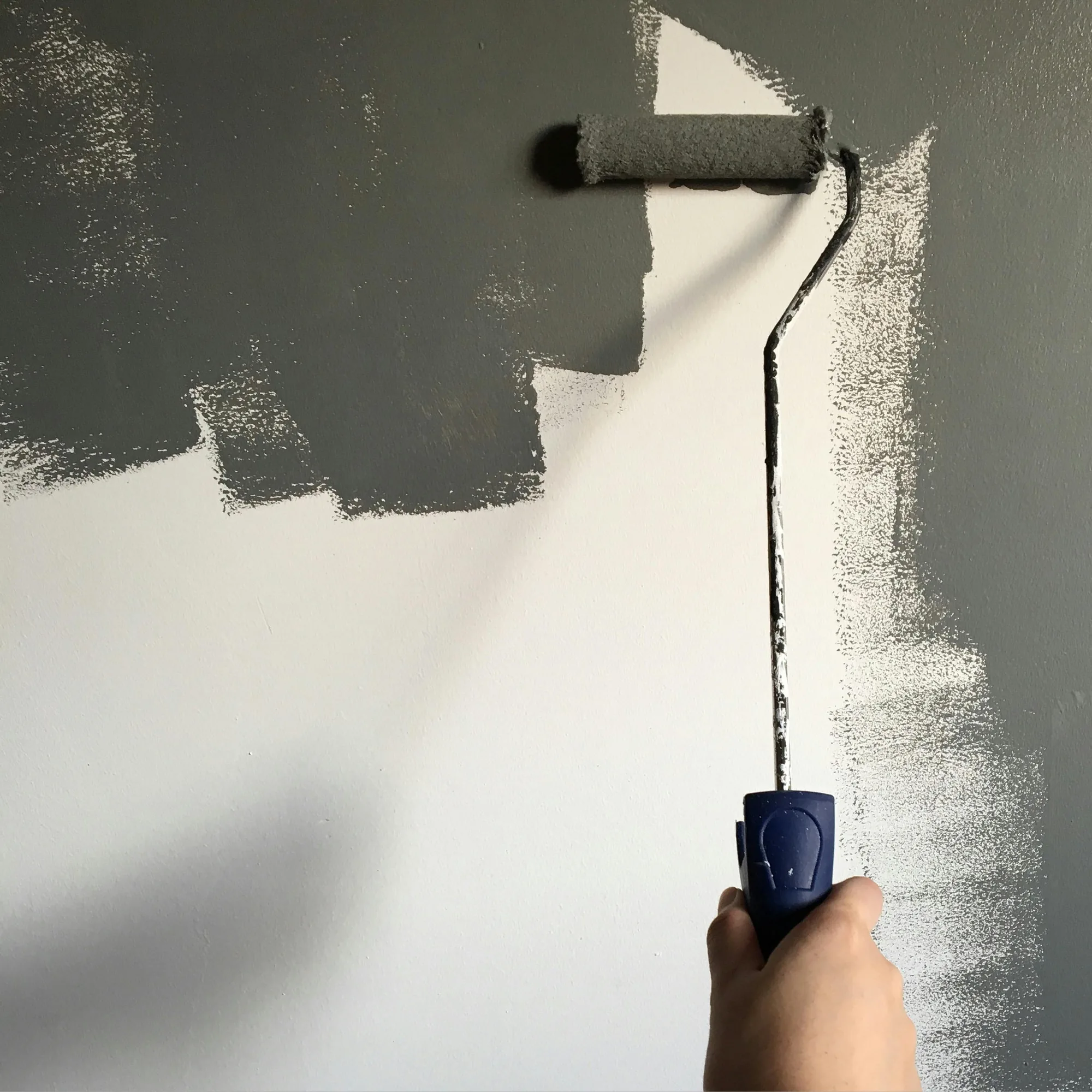 Schilderwerk met verfroller op een wand